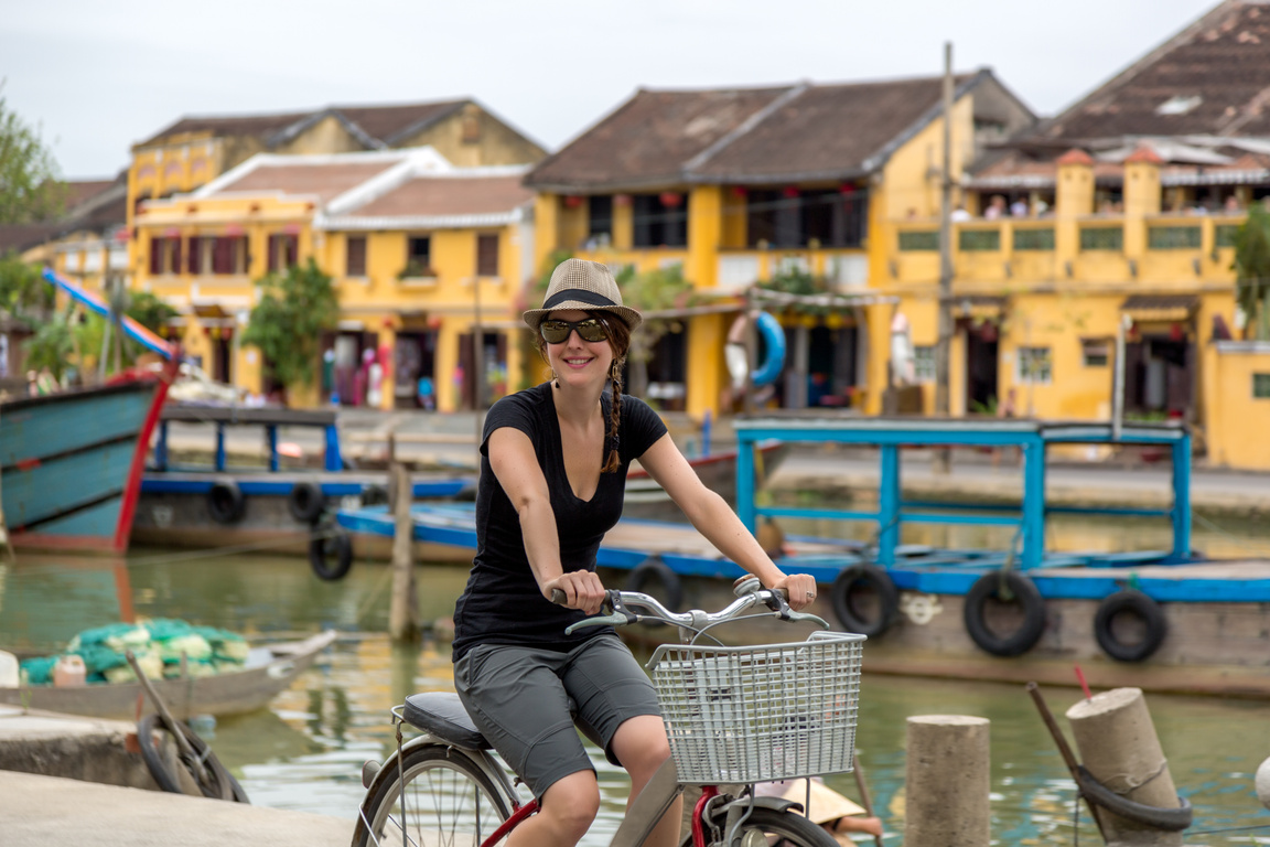 Woman Tourist Cycling in Hoi An City, Vietnam