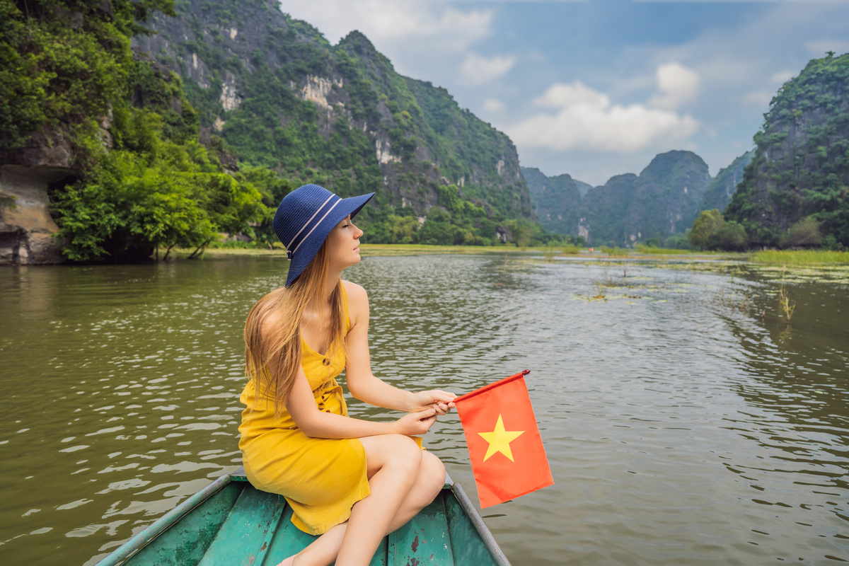 Woman Tourist in Boat on the Lake Tam Coc, Ninh Binh, Vietnam